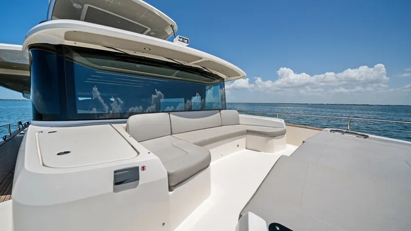 Slide: The Image of Flybridge Seating Area with Ocean View The flybridge of the Absolute Navetta 58 offers a spacious seating area with panoramic ocean views. Elegant, cushioned seating provides comfort and style, while the sleek design complements the modern lines of the vessel. Perfect for relaxation and social - 7018671