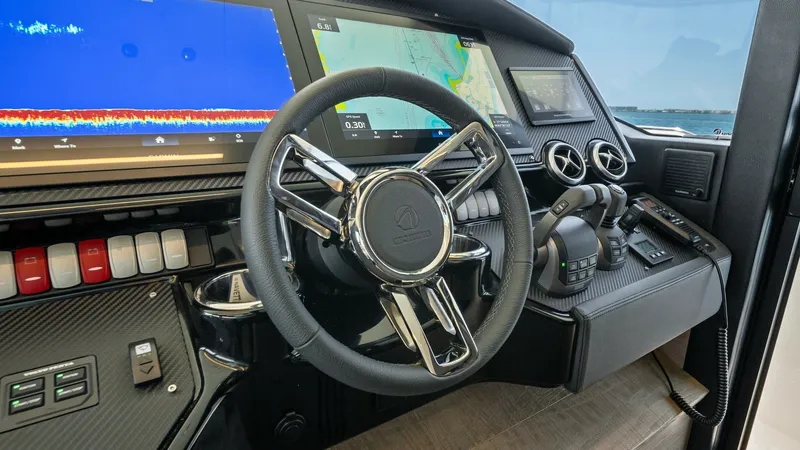 Slide: The Image of Modern Helm Station with Electronics The helm station of the 2026 Absolute Navetta 58 showcases cutting-edge navigation technology with dual multifunction displays for seamless chart plotting and sonar readings. The sleek, carbon-fiber dashboard is equipped with intuitive controls and a styl - 7018641
