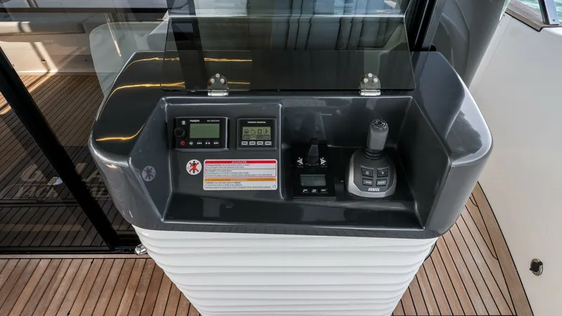 Slide: The Image of Cockpit Control Station The cockpit control station on the Absolute Navetta 58 is designed for seamless maneuverability. Featuring state-of-the-art digital displays and an ergonomic joystick, it ensures precise navigation. The sleek design integrates effortlessly with the yacht' - 7018654