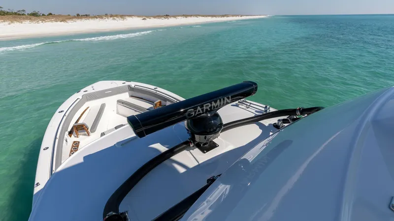 Slide: The Image of Bow and Upper Helm View This image showcases the sleek bow of the 2023 Everglades 455 Center Console, highlighting its spacious seating area designed for relaxation and enjoyment. The upper helm features advanced navigation equipment, ensuring a cutting-edge boating experience. - 7095089