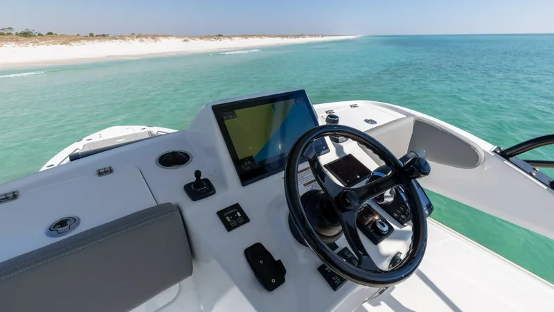 Slide: The Image of Helm Station with Expansive View The helm station of the 2023 Everglades 455 Center Console offers state-of-the-art navigation technology, featuring a sleek control panel and ergonomic steering wheel. The large touchscreen display provides easy access to vital information and controls, e - 7095090