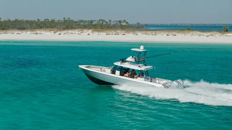 Slide: The Image of Side View Cruising in Turquoise Waters The 2023 Everglades 455 Center Console, named Cash Cow, is seen cruising effortlessly through vibrant turquoise waters. This vessel showcases a sleek and modern design with a spacious deck layout, perfect for both fishing and leisure. Its powerful perform - 7095100