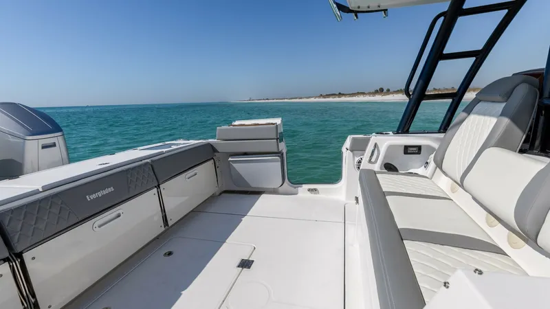 Slide: The Image of Aft Deck Seating and Storage Area This image showcases the spacious aft deck of the 2023 Everglades 455 Center Console, featuring comfortable seating and ample storage options. The clean, modern design is complemented by high-quality materials, offering both functionality and style. Enjoy - 7095064