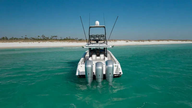 Slide: The Image of Aft View with Quad Engines This image showcases the aft view of the 2023 Everglades 455 Center Console, highlighting its impressive quad outboard engines. The sleek design is complemented by the vessel's advanced propulsion system, ensuring high performance and efficiency. Set agai - 7095095