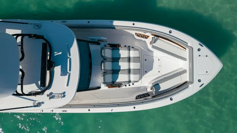 Slide: The Image of Spacious Bow Seating Area The Everglades 455 Center Console features a luxurious bow seating area perfect for relaxation and socializing. Plush, comfortable seating is complemented by elegant wood accents and built-in cup holders. The open layout offers unobstructed views and easy - 7095097