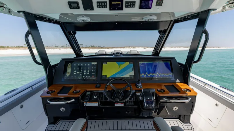 Slide: The Image of Helm Station with Advanced Electronics The helm station of the 2023 Everglades 455 Center Console features state-of-the-art electronics and a sleek, modern design. Multiple high-resolution displays provide comprehensive navigation and system controls, while the ergonomic layout ensures ease of - 7095066