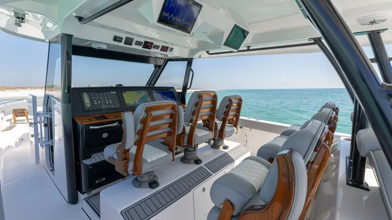Slide: The Image of Helm Station with Premium Seating The helm station of the 2023 Everglades 455 Center Console features state-of-the-art navigation systems and luxurious seating for the captain and passengers. Elegant wooden accents complement the plush, cushioned chairs, ensuring comfort on extended voyag - 7095059