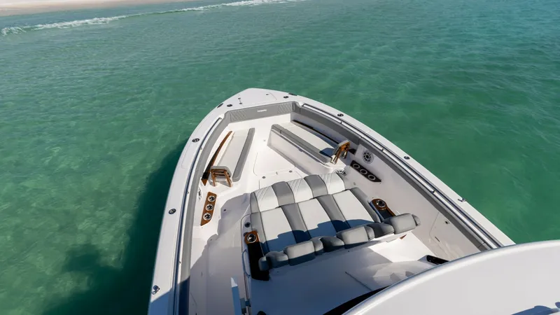 Slide: The Image of Spacious Bow Seating Area The bow of the 2023 Everglades 455 Center Console, 'Cash Cow', features a luxurious seating area with plush cushions for optimal comfort. The sleek design is complemented by high-quality materials and ample storage compartments. This inviting space offers - 7095084