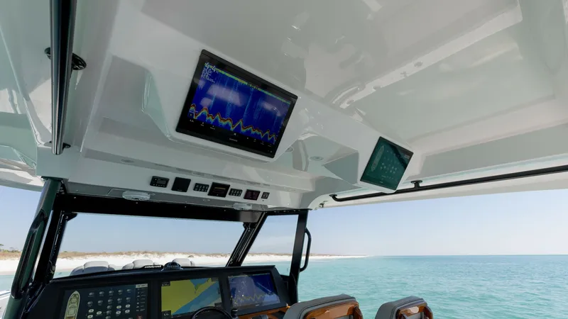 Slide: The Image of Helm Station with Advanced Electronics The helm station of the 2023 Everglades 455 Center Console, 'Cash Cow', features cutting-edge electronics and navigation systems. Dual high-resolution displays provide critical data and chart plotting capabilities, ensuring a seamless sailing experience. - 7095069