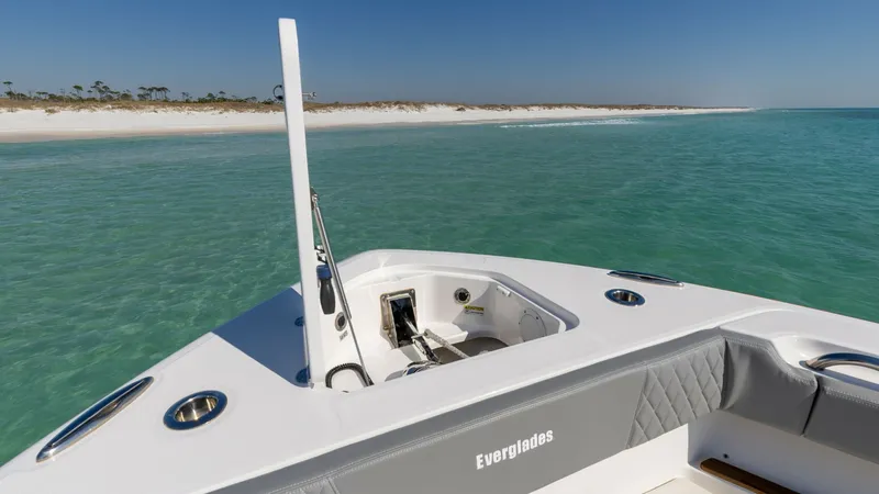 Slide: The Image of Bow View with Anchor Locker This image showcases the sleek bow of the 2023 Everglades 455 Center Console, highlighting its spacious anchor locker. The clean lines and durable finishes provide both functionality and elegance. The surrounding tranquil waters and distant shoreline add - 7095083