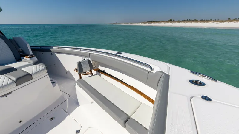 Slide: The Image of Spacious Bow Seating Area The bow of the 2023 Everglades 455 Center Console offers luxurious seating with plush, cushioned benches perfect for relaxation. This area provides an unobstructed view of the surrounding waters, ideal for enjoying a day on the ocean. The clean lines and - 7095082