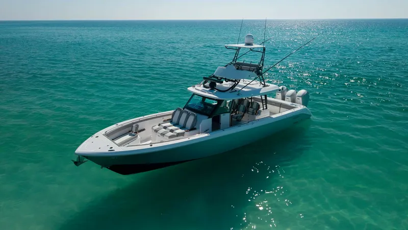 Slide: The Image of Aerial View of 455 Center Console This image showcases the sleek design of the 2023 Everglades 455 Center Console, known as 'Cash Cow.' The vessel features a spacious deck with ample seating, perfect for entertaining or relaxing. Its elegant lines and modern amenities are highlighted agai - 7095092