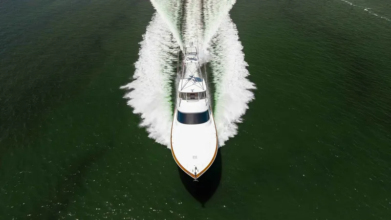 Slide: The Image of Aerial View of Bow in Motion This striking aerial shot captures the 2016 Viking 80 Convertible slicing through the water with precision. The vessel's sleek bow design is showcased as it cuts through the waves, creating an impressive wake. The elegant lines and powerful performance ar - 7150219