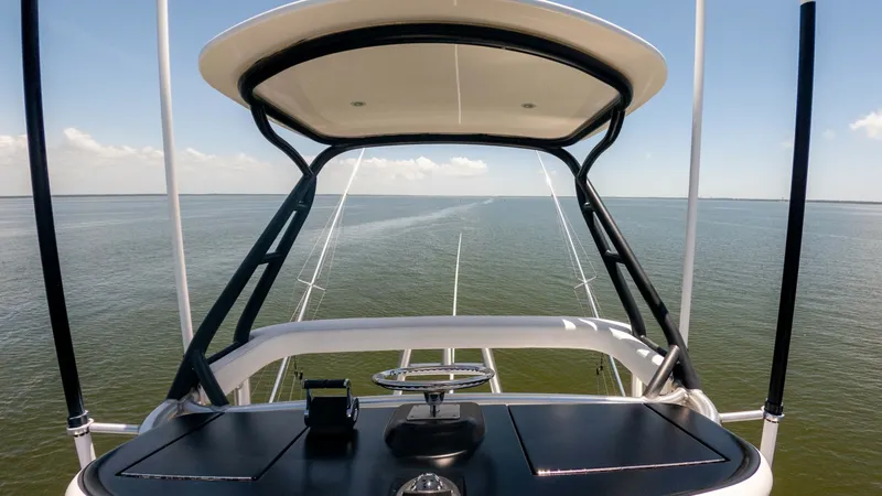 Slide: The Image of Tower Helm with Panoramic View Experience commanding views from the flybridge helm of the 2016 Viking 80 Convertible. The sleek, modern design features a well-equipped console with advanced navigation controls, offering both functionality and style. Enjoy uninterrupted vistas of the op - 7150208