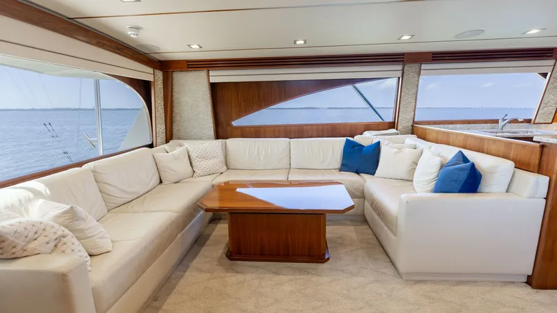 Slide: The Image of Spacious Salon with Panoramic Views The salon of this 2016 Viking 80 Convertible offers a luxurious and inviting space with plush, cream-colored seating. The large windows provide panoramic views of the sea, enhancing the open and airy feel. Rich wood accents and a polished coffee table add - 7150161