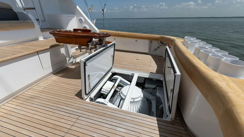 Slide: The Image of Cockpit with Engine Room Access The cockpit of this 2016 Viking 80 Convertible features a sleek, teak deck with convenient access to the engine room. The spacious area is designed for both functionality and leisure, equipped with rod holders and a polished fighting chair for the avid an - 7150201
