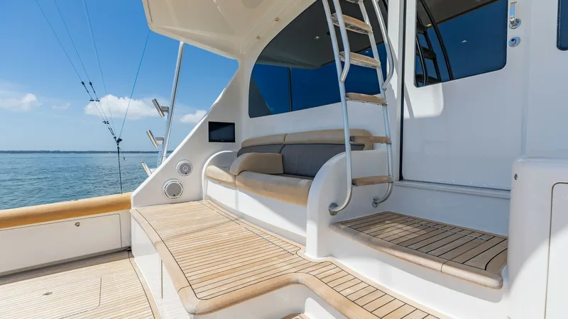 Slide: The Image of Spacious Aft Deck with Ladder Access This 2016 Viking 80 Convertible features a well-designed aft deck, complete with comfortable seating and a sleek teak finish. The integrated ladder provides easy access to the upper levels, enhancing the vessel's functionality. Enjoy stunning views and am - 7150198