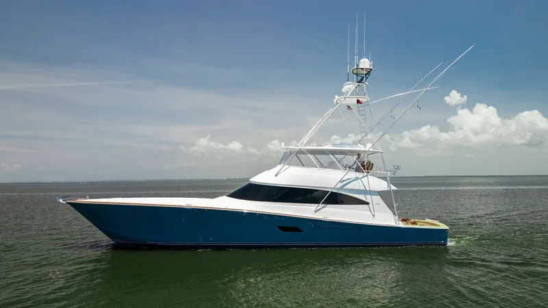 The Image of Side Profile of Viking 80 Convertible This image showcases the sleek side profile of the 2016 Viking 80 Convertible, highlighting its striking blue hull and elegant lines. The vessel's towering flybridge and outriggers are prominently visible, emphasizing its sportfishing capabilities. With i - 7150156