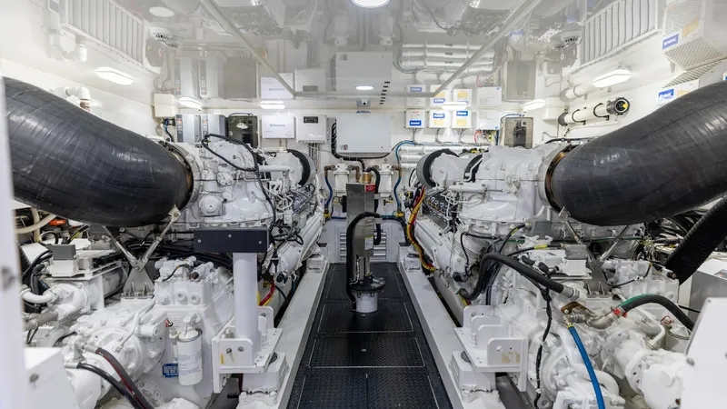 Slide: The Image of Engine Room with Twin Engines This image showcases the meticulously maintained engine room of the 2016 Viking 80 Convertible. It features powerful twin engines, highlighting the vessel's robust engineering and performance capabilities. The space is well-organized and illuminated, ensu - 7150210