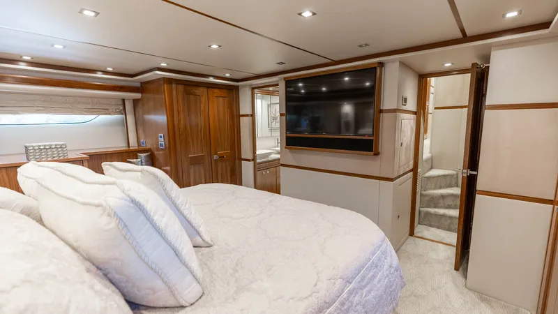 Slide: The Image of Master Stateroom with Ensuite Access The master stateroom features a luxurious queen-sized bed adorned with plush bedding, creating a cozy and inviting atmosphere. Rich wood paneling and soft recessed lighting enhance the elegant design, while a large flat-screen TV ensures entertainment at - 7150179