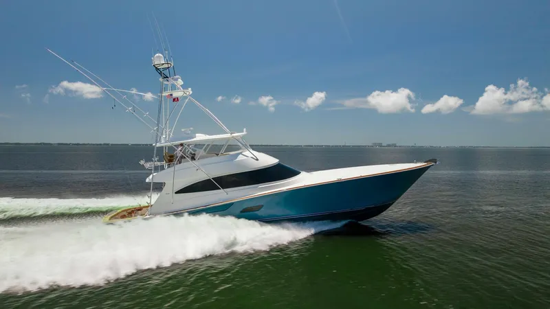 Slide: The Image of Viking 80 Convertible Cruising The 2016 Viking 80 Convertible slices through the water with elegance and power, showcasing its sleek hull design. The yacht's impressive speed and stability are highlighted against a backdrop of open sea and clear skies. This vessel embodies luxury sport - 7150221