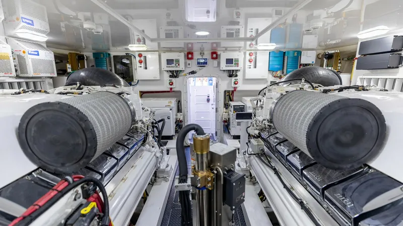 Slide: The Image of Engine Room with Twin Engines This image showcases the meticulously organized engine room of the 2016 Viking 80 Convertible. Featuring twin high-performance engines, the space is designed for optimal functionality and ease of access. The clean, well-lit environment highlights advanced - 7150214