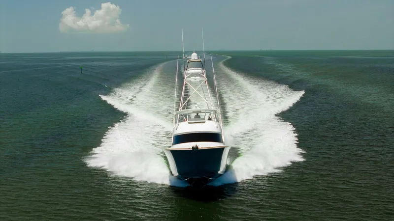 Slide: The Image of Bow View in Motion The 2016 Viking 80 Convertible is showcased in dynamic motion, cutting through the water with precision. Its sleek bow design emphasizes both power and elegance, while the wake highlights the vessel's impressive speed and agility. The open sea and clear s - 7150223