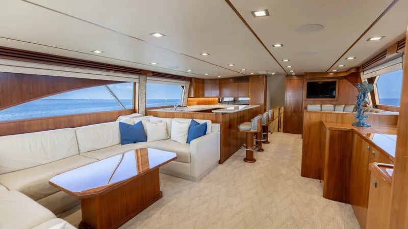 Slide: The Image of Luxurious Salon with Ocean Views This elegant salon aboard the 2016 Viking 80 Convertible features plush cream-colored seating with rich wood accents, creating a warm and inviting ambiance. Large windows provide stunning ocean views and abundant natural light, enhancing the open and airy - 7150160