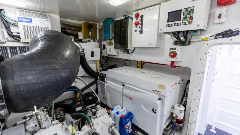 Slide: The Image of Engine Room with Generator The engine room of the 2016 Viking 80 Convertible showcases a well-organized layout featuring a powerful generator and advanced control systems. The space is efficiently designed for optimal performance and accessibility, with high-quality components and - 7150211