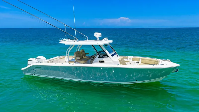 Slide: The Image of Side View of Pursuit 328 This image showcases the sleek side profile of the 2019 Pursuit 328, named Orcabessa. The vessel's elegant lines and spacious deck offer a perfect blend of style and functionality. Equipped with dual outboard engines, this model is designed for both leisu - 7095013