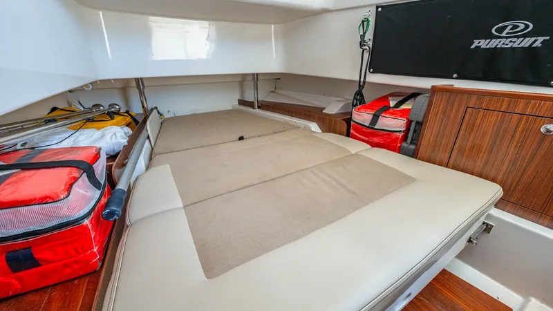 Slide: The Image of Convertible Cabin Lounge Area This versatile cabin space on the 2019 Pursuit 328 offers a comfortable lounging area that can easily convert for additional utility. The well-appointed interior features soft, cushioned seating and elegant wood accents, providing both comfort and style. - 7095048