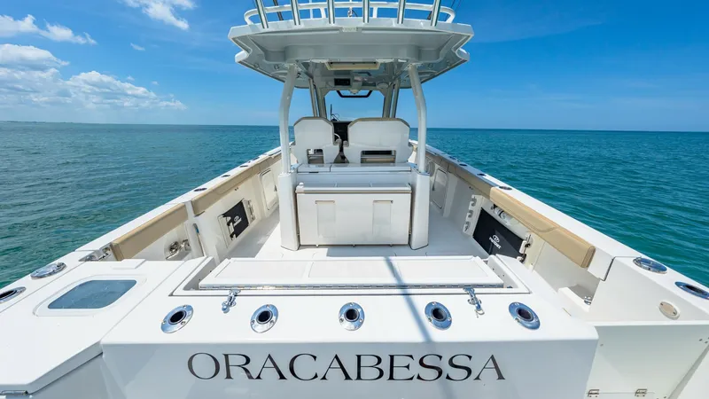 Slide: The Image of Aft Deck and Helm Station View This image showcases the spacious aft deck of the 2019 Pursuit 328, featuring ample seating and a well-equipped helm station. The clean deck layout emphasizes functionality, with rod holders and storage compartments ideal for fishing enthusiasts. The clea - 7095024