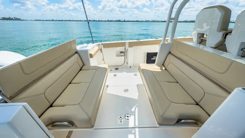 Slide: The Image of Spacious Aft Deck Seating Area This inviting aft deck of the 2019 Pursuit 328, Orcabessa, features plush, wrap-around seating perfect for social gatherings. The ergonomic design and premium upholstery provide comfort and style, while offering expansive views of the surrounding waters. - 7095012