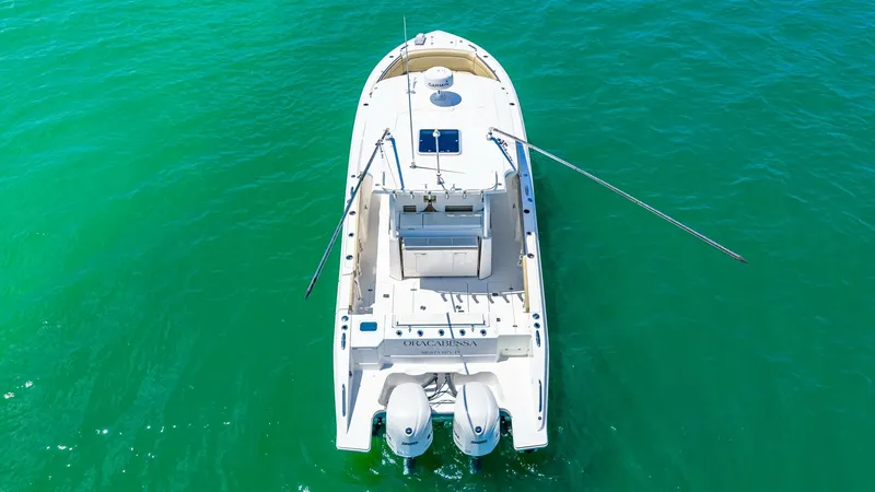 Slide: The Image of Aerial View of Aft Deck This aerial shot of the 2019 Pursuit 328, Orcabessa, highlights the spacious aft deck designed for both relaxation and fishing. The dual outboard engines provide powerful performance, while the integrated rod holders and ample seating showcase its versati - 7095022