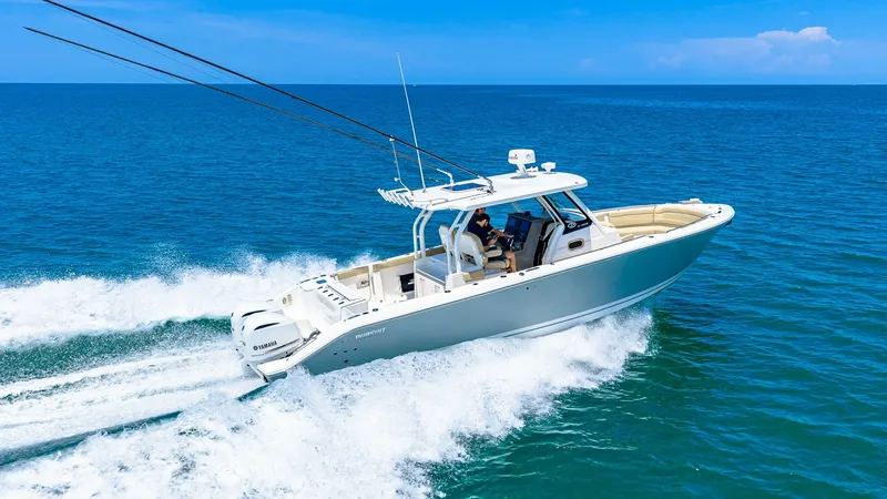 Slide: The Image of Dynamic Aerial View of Pursuit 328 The Pursuit 328 Orcabessa is captured slicing through the ocean with impressive speed and agility. Its sleek design and powerful outboard engines are on full display, highlighting the vessel's performance capabilities. The spacious deck layout offers ampl - 7095053