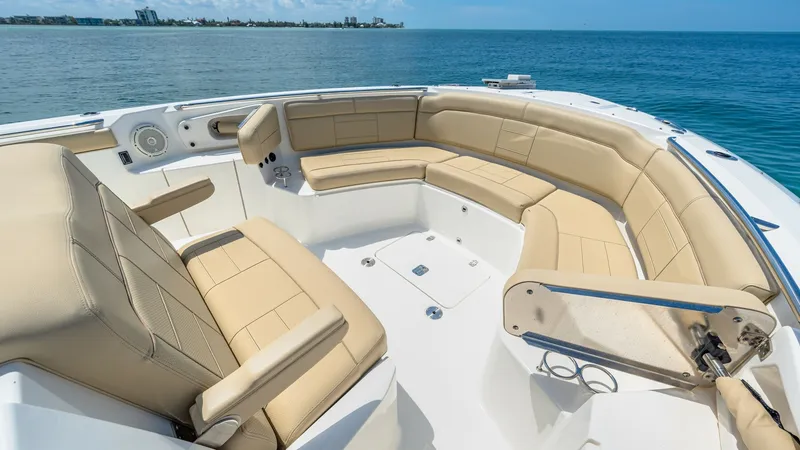 Slide: The Image of Spacious Bow Seating Area The bow of the 2019 Pursuit 328, Orcabessa, features a luxurious seating area with plush, tan-colored cushions ideal for relaxation. This space offers ample room for guests to enjoy the panoramic ocean views. The sleek, modern design is complemented by hi - 7095041