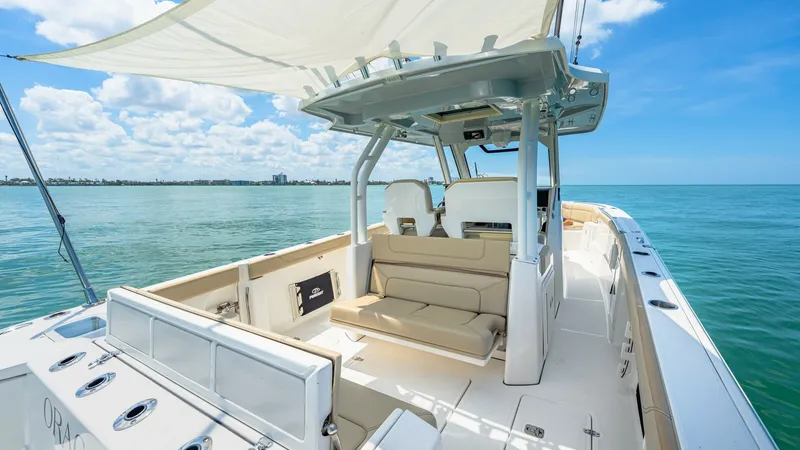 Slide: The Image of Spacious Cockpit with Shade Canopy The 2019 Pursuit 328 features a spacious cockpit area, perfect for relaxation and entertaining. The elegant seating arrangement is complemented by a sleek shade canopy, providing ample protection from the sun. Stainless steel fixtures and a well-appointed - 7095011
