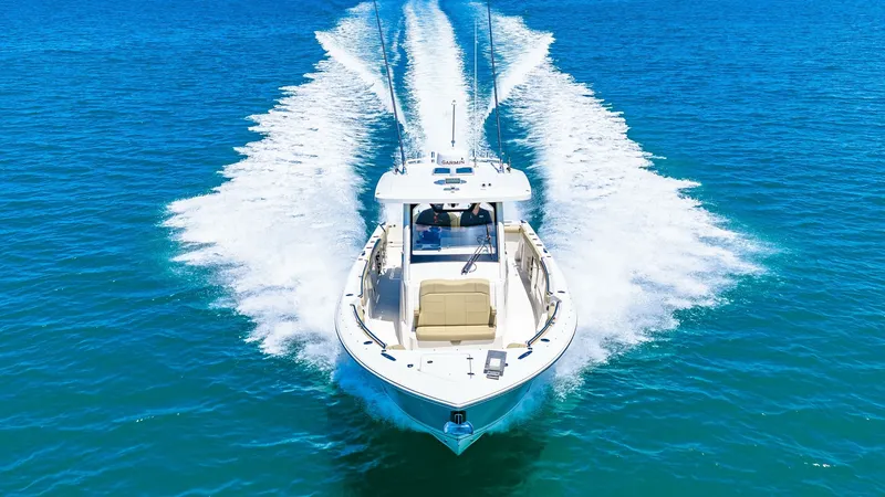 Slide: The Image of Aerial View of Bow Underway The Pursuit 328, Orcabessa, cuts through the water with impressive agility, showcasing its sleek design and powerful performance. From this aerial perspective, the spacious bow area is visible, designed for both comfort and functionality while at sea. The - 7095050