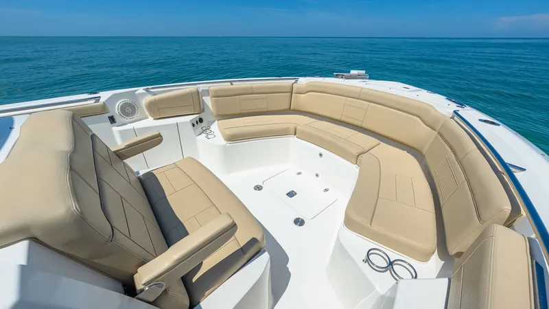 Slide: The Image of Spacious Bow Seating Area The bow of the 2019 Pursuit 328, Orcabessa, features a luxurious and spacious seating area with plush, tan upholstery. Designed for comfort and socializing, this area offers ample seating with integrated cup holders and a sleek, modern design. Enjoy breat - 7095040