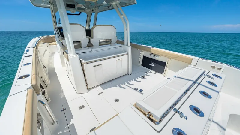 Slide: The Image of Spacious Aft Deck with Seating The Pursuit 328's aft deck offers ample space for relaxation and entertainment, featuring plush seating with sturdy backrests. The deck is equipped with multiple rod holders and a well-organized layout, making it ideal for both leisure and fishing activit - 7095032