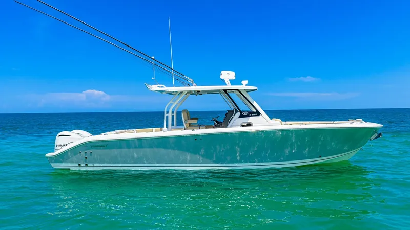 The Image of Starboard Profile of Pursuit 328 This side view of the 2019 Pursuit 328 showcases its sleek, modern design and spacious deck layout. The boat is equipped with high-quality fishing rods, a robust hardtop, and ample seating for comfort during long voyages. Its elegant hull glides smoothly - 7095007