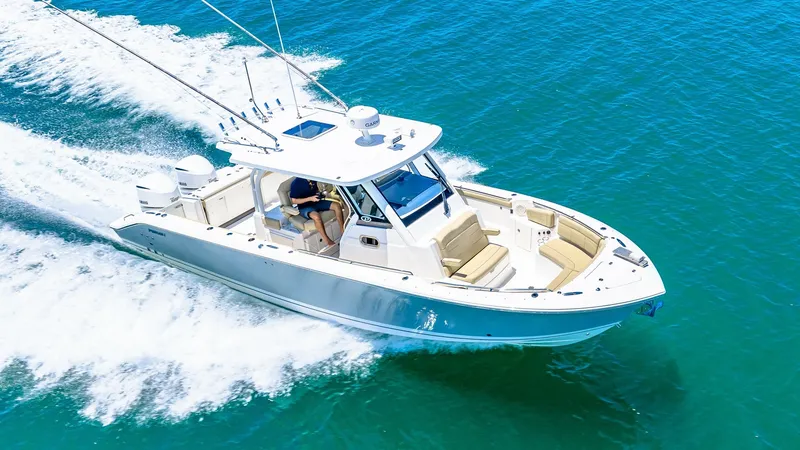 Slide: The Image of Aerial View of Bow and Helm This aerial view showcases the sleek design of the Pursuit 328's bow and helm. The spacious seating area at the bow provides comfort and style, perfect for lounging or entertaining while cruising. The helm is equipped with modern controls and electronics, - 7095051