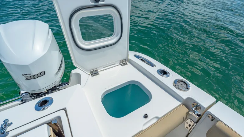 Slide: The Image of Aft Deck Livewell and Engine The aft deck of the 2019 Pursuit 328 features a spacious livewell, perfect for keeping your catch fresh. Adjacent to the powerful Yamaha 300 engine, the area is designed with convenience and functionality in mind. The sleek white finish and ergonomic layo - 7095029