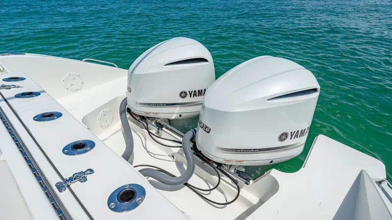 Slide: The Image of Twin Yamaha Outboard Engines This image showcases the twin Yamaha outboard engines on the 2019 Pursuit 328, emphasizing power and reliability. The sleek, white engine casings complement the vessel's modern aesthetic, while the stainless steel fittings add a touch of elegance. Designe - 7095028