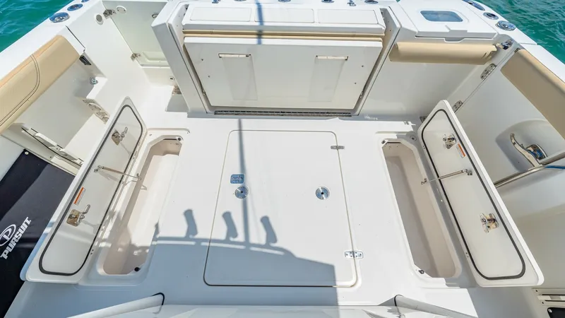 Slide: The Image of Spacious Aft Deck with Storage The aft deck of the 2019 Pursuit 328 offers ample space for relaxation and activities. Featuring multiple storage compartments, this area is designed for convenience, ensuring all your gear is neatly stowed away. The clean, modern layout enhances function - 7095033