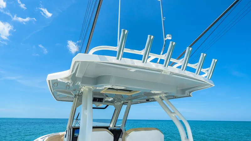 Slide: The Image of Hardtop with Rod Holders The Pursuit 328 features a sleek hardtop equipped with multiple rod holders, perfect for avid anglers. This area provides excellent shade and protection, enhancing comfort while navigating open waters. The modern design integrates seamlessly with the vess - 7095018