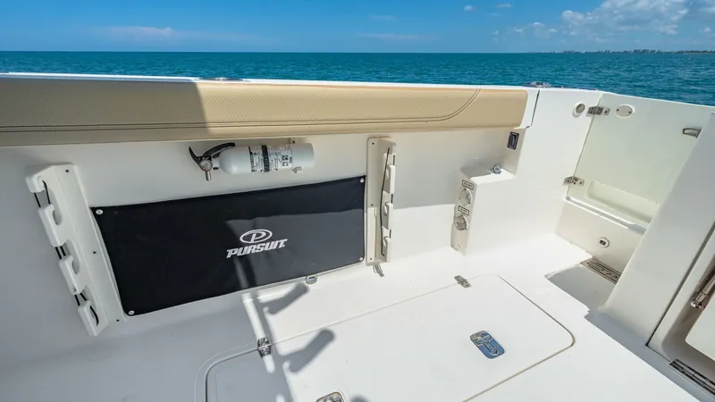 Slide: The Image of Spacious Aft Deck with Storage The aft deck of the 2019 Pursuit 328 Orcabessa showcases a clean and spacious layout, ideal for fishing and relaxation. Featuring integrated rod holders and a secure storage compartment, this area is designed for both functionality and comfort. The cushio - 7095030