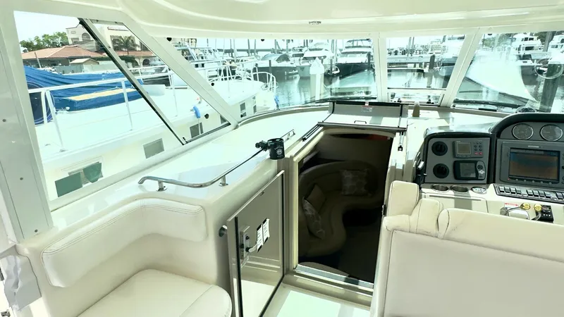 Slide: The Image of Upper Helm and Seating Area The upper helm of the 2006 Sea Ray 40 Motor Yacht offers a commanding view with plush seating for comfort and convenience. The helm is equipped with advanced navigation instruments and ergonomic controls, ensuring ease of operation. Large windows provide - 7150637