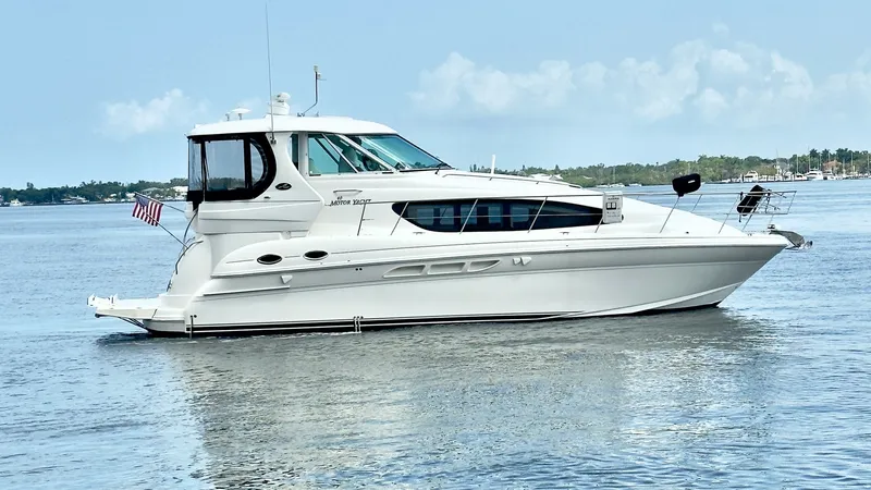 Slide: The Image of Starboard Profile of Sea Ray 40 This image showcases the sleek starboard profile of the 2006 Sea Ray 40 Motor Yacht 'Knot on Call.' The vessel's elegant lines and well-proportioned hull are complemented by large windows that provide ample natural light to the interior. The flybridge and - 7150655