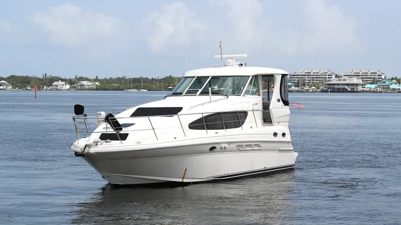 Slide: The Image of Bow View of Sea Ray 40 Motor Yacht This image showcases the sleek bow of the 2006 Sea Ray 40 Motor Yacht, 'Knot on Call.' The vessel's modern design is highlighted by its streamlined profile and large, tinted windows, offering expansive views and natural light. The sturdy bow rail and spac - 7150659